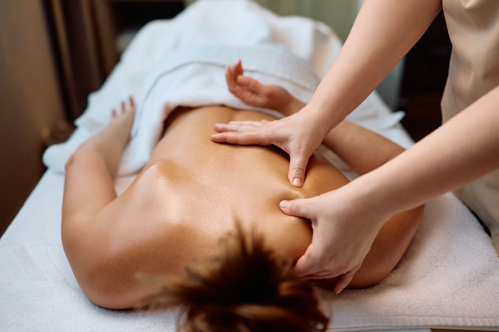 Unrecognizable woman having back massage at health spa.